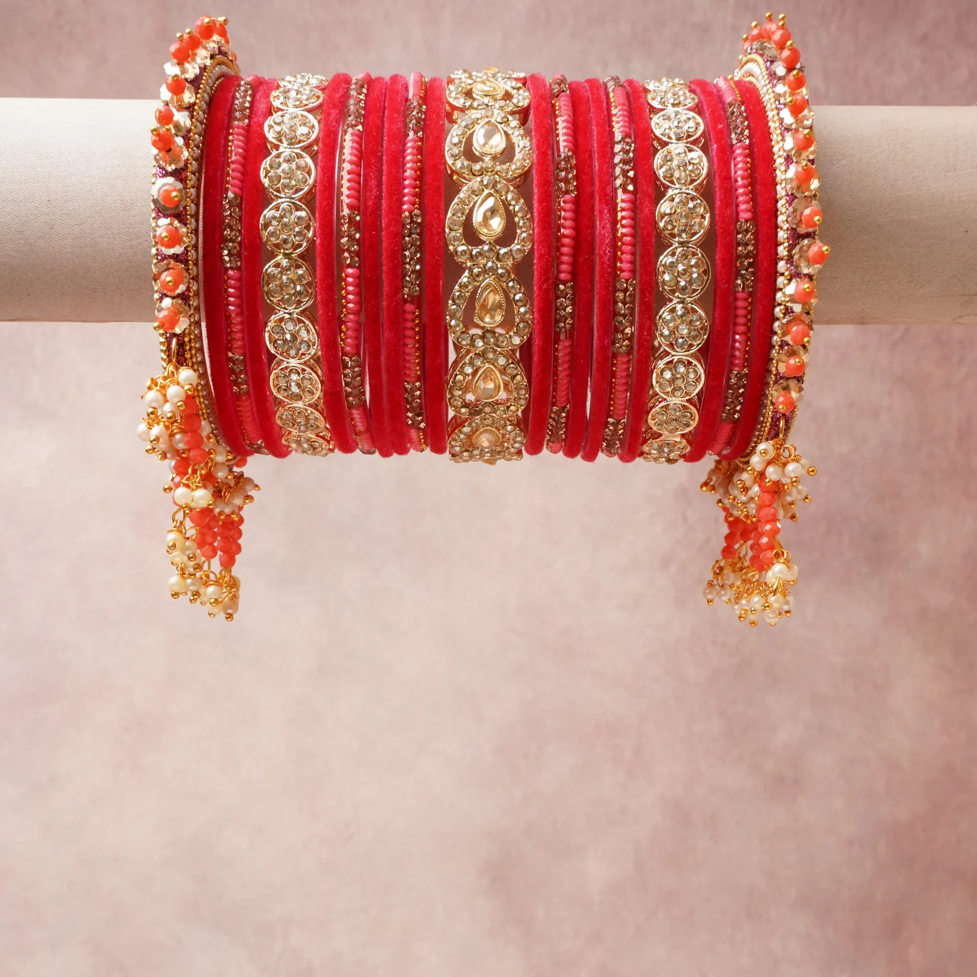 A commanding Crimson Red anchors this beautiful set, enriched with accents of Gold, Clear, Coral Pink, Pearl White that add depth and dimension.

Featuring a striking composition of Velvet Fabric, Gold-toned Metal Alloy, Cubic Zirconia, Glass Beads, Imitation Pearls, this set carries intricate craftsmanship and strong presence. Grand in form, it is created for moments that deserve to be marked.